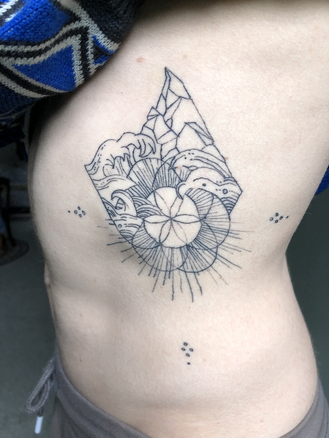 Fine-line shell and waves tattoo