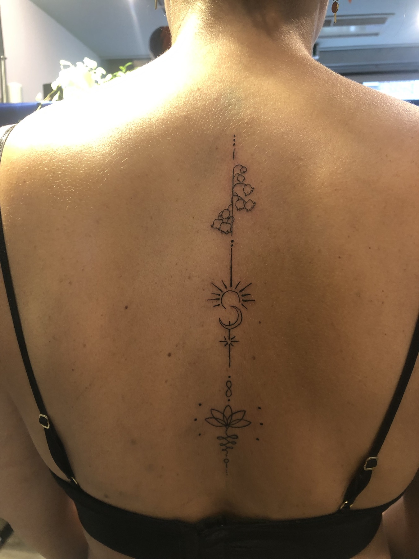 Fine-line spine tattoo