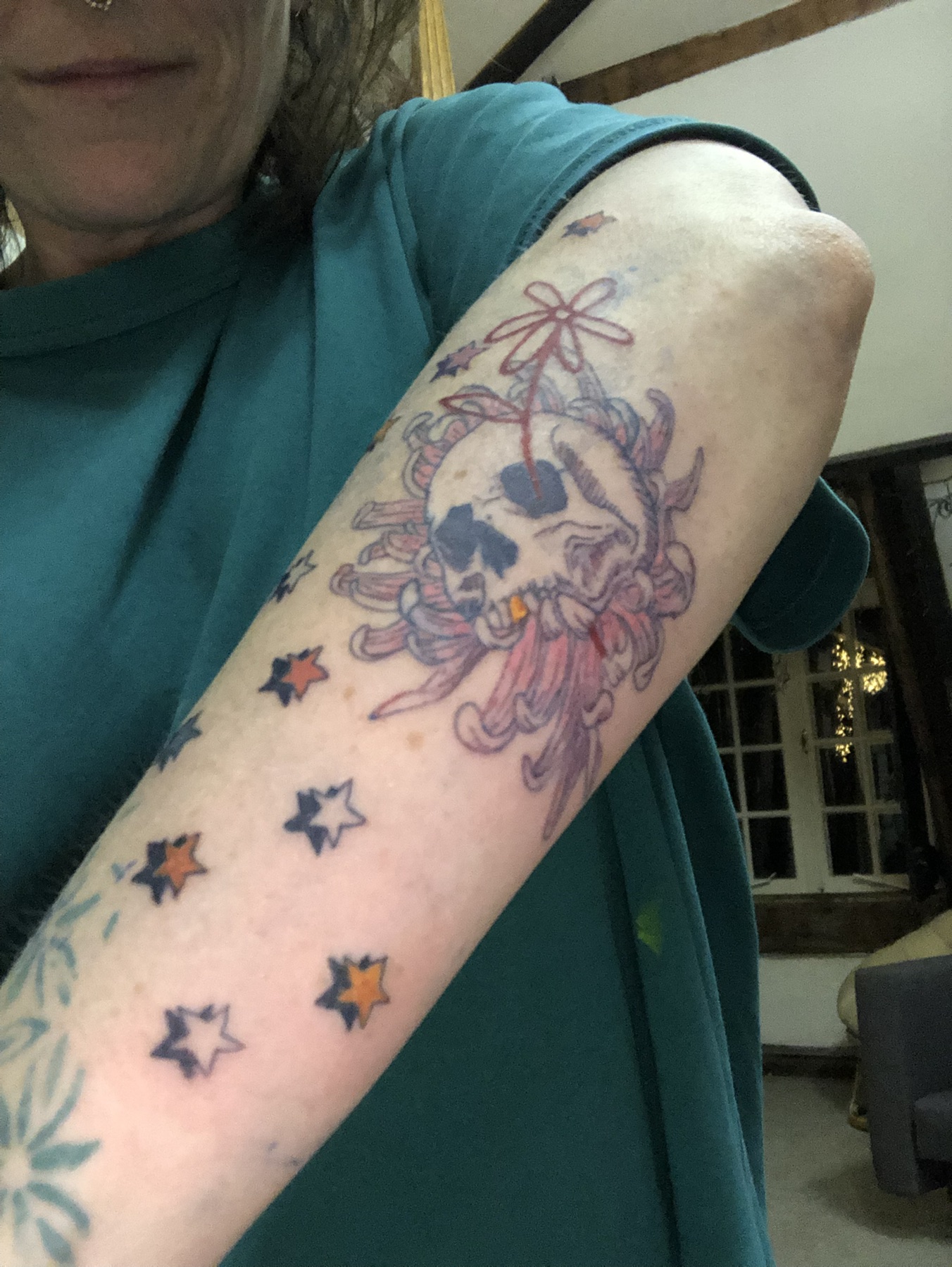 Colour skull and bow tattoo