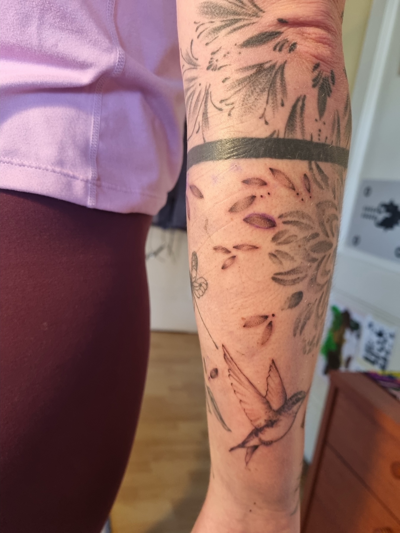 Bird and botanical sleeve tattoo